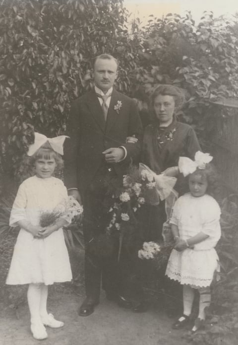 Wedding portrait with bride, groom, and two flower girls